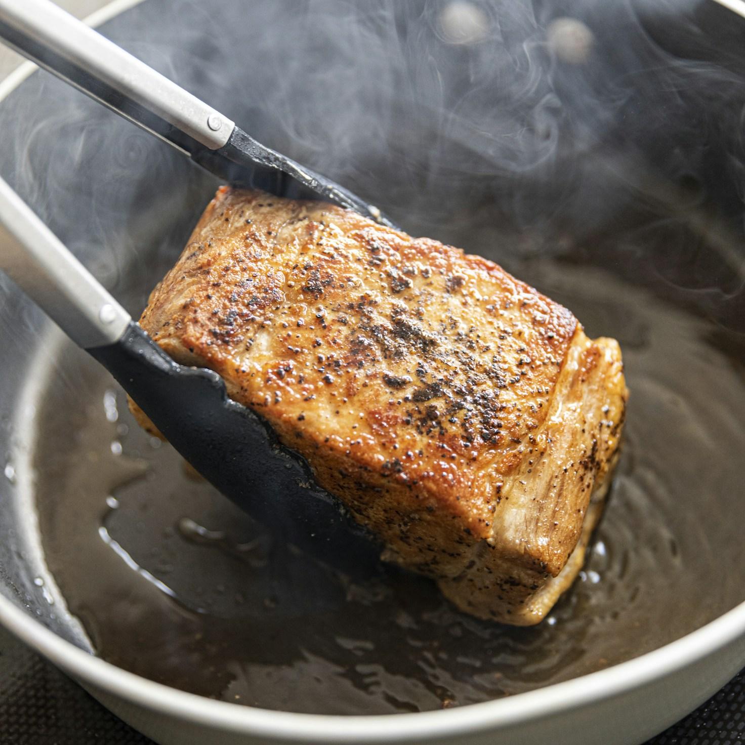 Community members collaborating in a modern kitchen space, sharing recipes and cooking techniques